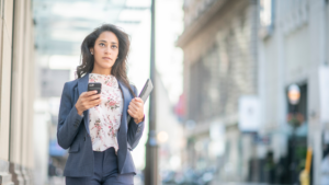 woman walking holding phone